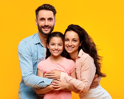 Happy parents hugging their daughter after buying new house